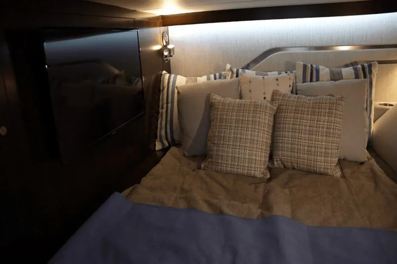 Slide: The Image of Luxurious cabin interior of 2022 Cruisers 42 GLS yacht with cozy bedding and ambient lighting. - 29