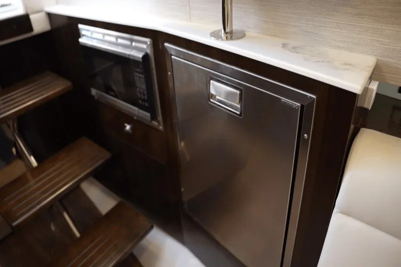 Slide: The Image of Luxurious 2022 Cruisers 42 GLS yacht interior with modern kitchen appliances and elegant wood finishes. - 30