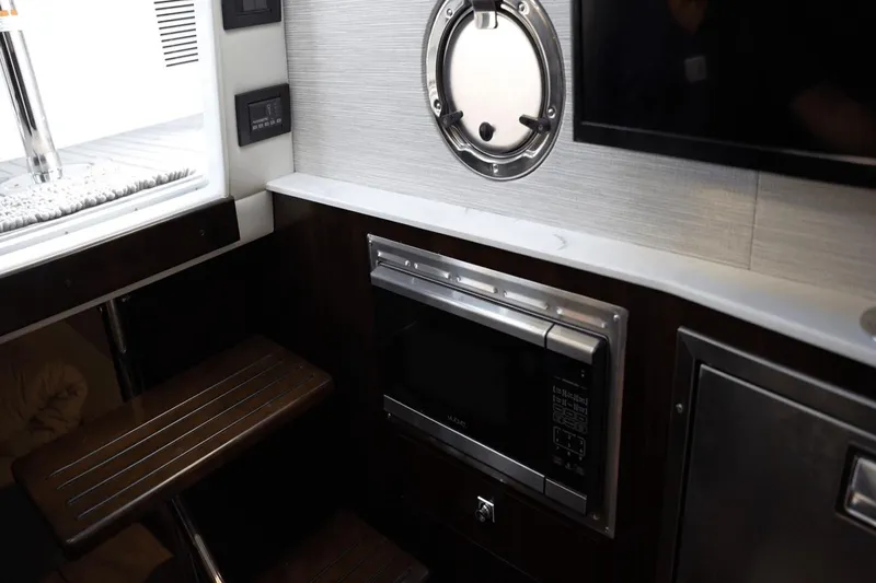 Slide: The Image of Interior of 2022 Cruisers 42 GLS yacht featuring microwave and porthole window. - 34