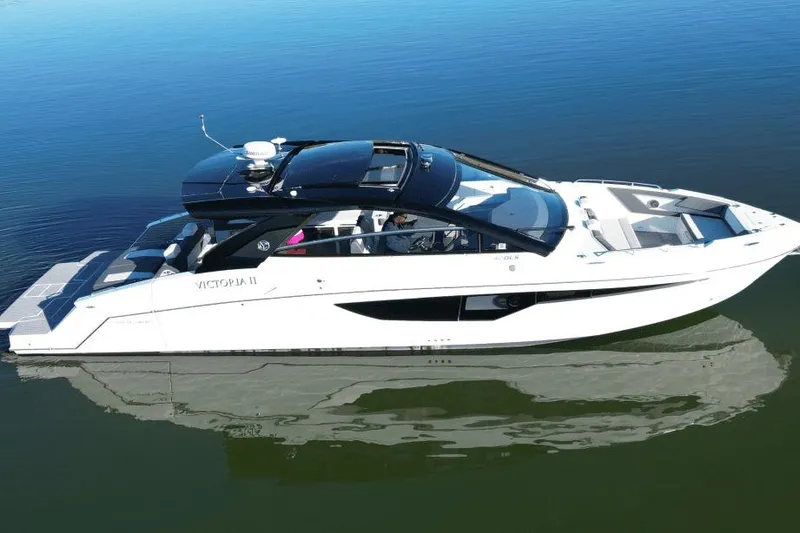 Slide: The Image of 2022 Cruisers 42 GLS yacht on calm water, sleek design, luxury features. - 4