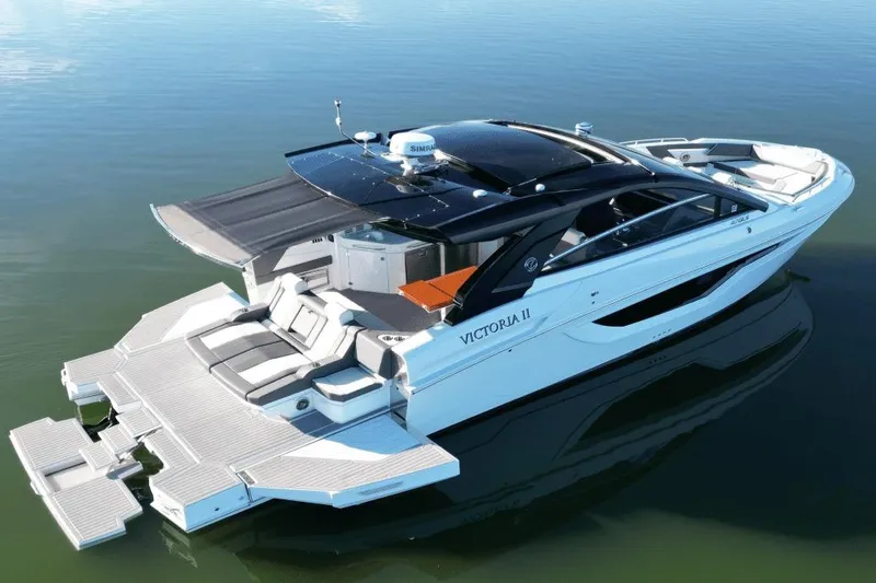 Slide: The Image of 2022 Cruisers 42 GLS luxury yacht with sleek design on calm water. - 5