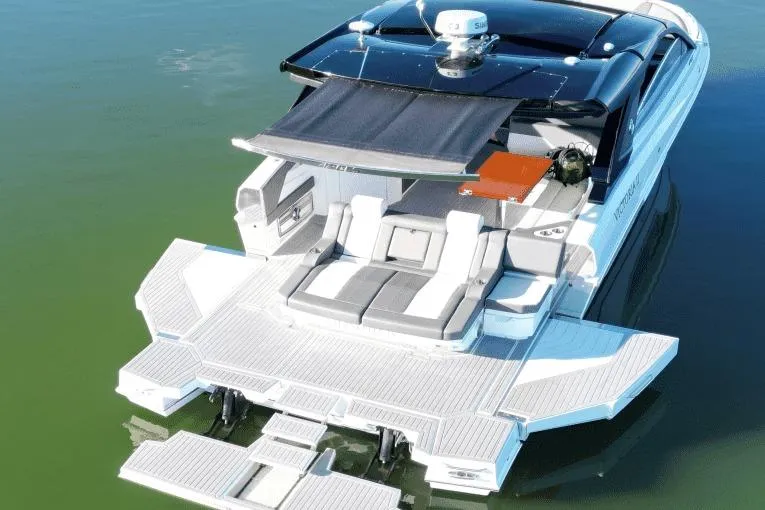 Slide: The Image of 2022 Cruisers 42 GLS luxury yacht with spacious deck and modern design on calm water. - 6