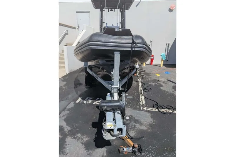 Slide: The Image of 2022 Zodiac 20 boat on trailer in parking lot, front view. - 11
