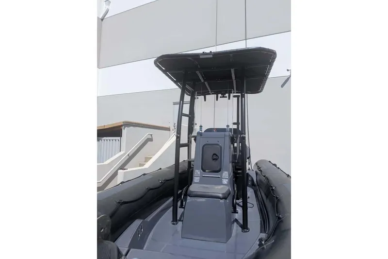Slide: The Image of 2022 Zodiac 20 boat with T-top canopy, docked outdoors. - 13