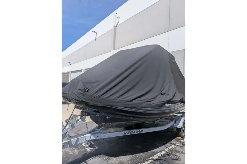 Slide: The Image of Covered Zodiac 20 boat on trailer, parked outdoors, 2022 model. - 15