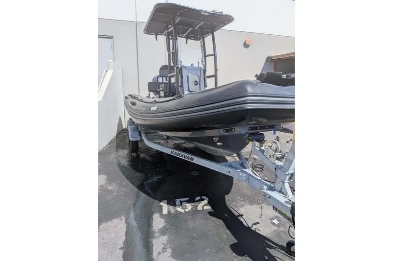 Slide: The Image of 2022 Zodiac 20 boat on Karavan trailer, parked outdoors. - 2