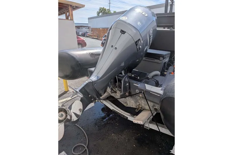 Slide: The Image of Outboard motor on a Zodiac 20 boat, 2022 model, parked outdoors. - 22