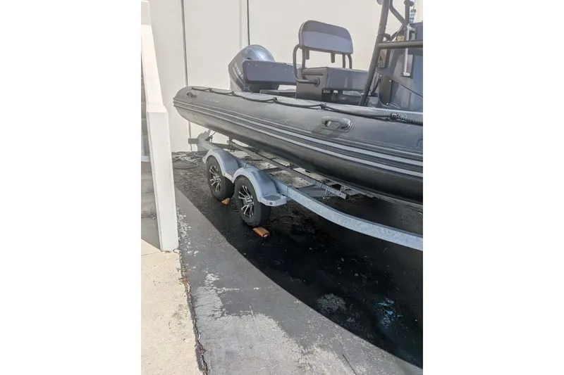Slide: The Image of Zodiac 20 boat on trailer, 2022 model, parked outdoors. - 26