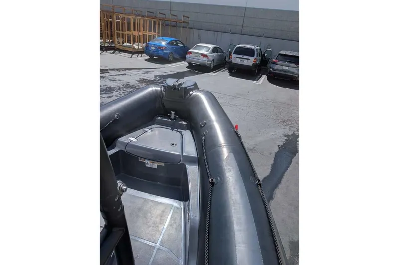 Slide: The Image of Zodiac 20 inflatable boat, 2022 model, parked in a lot with cars. - 4