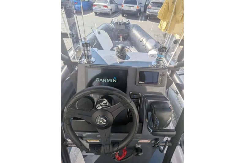 Slide: The Image of Cockpit of 2022 Zodiac 20 boat with Garmin navigation system and steering wheel. - 5