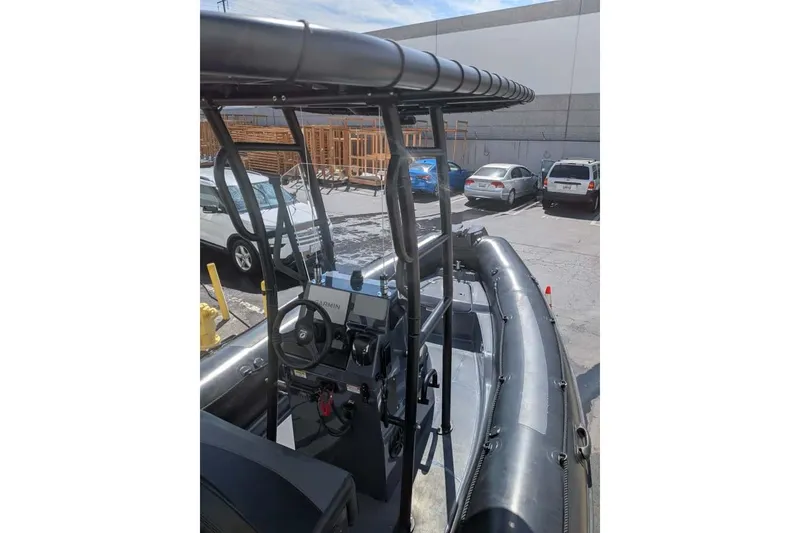 Slide: The Image of 2022 Zodiac 20 inflatable boat with steering console, parked in a lot. - 8