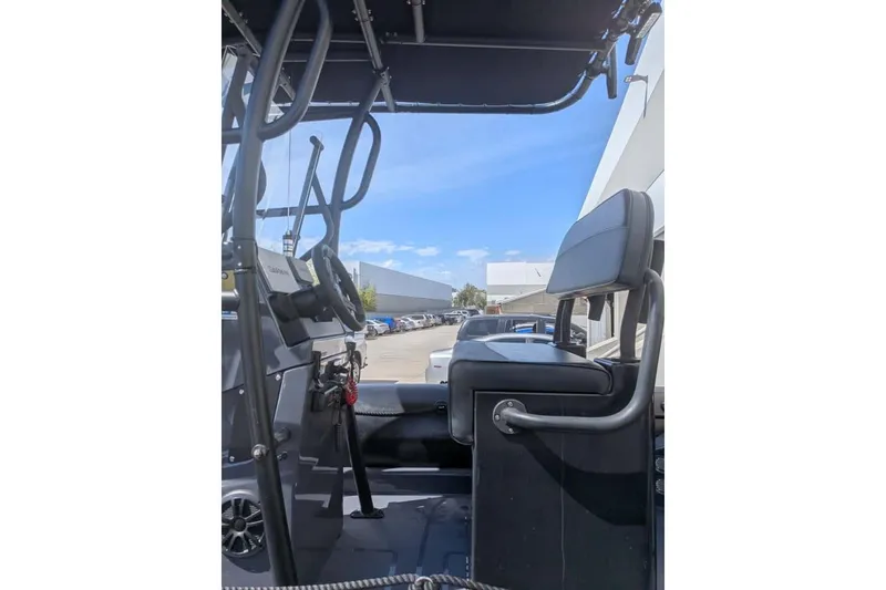 Slide: The Image of Interior view of a 2022 Zodiac 20 boat, showcasing steering and seating. - 9