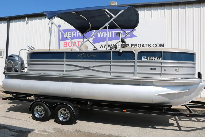 The Image of 2017 Berkshire 22 RFX Cts Tri-toon boat on trailer, with canopy, parked outside. - 1