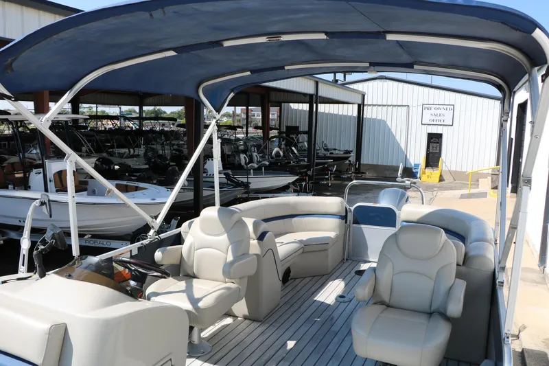 Slide: The Image of 2017 Berkshire 22 RFX Cts Tri-toon boat with spacious seating and canopy at a marina. - 23
