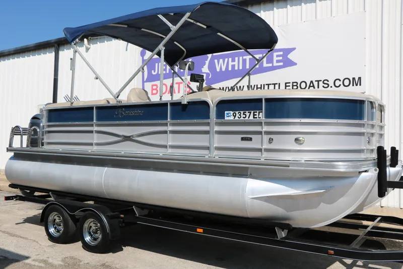 Slide: The Image of 2017 Berkshire 22 RFX Cts Tri-toon pontoon boat on trailer, blue canopy, parked outside. - 3