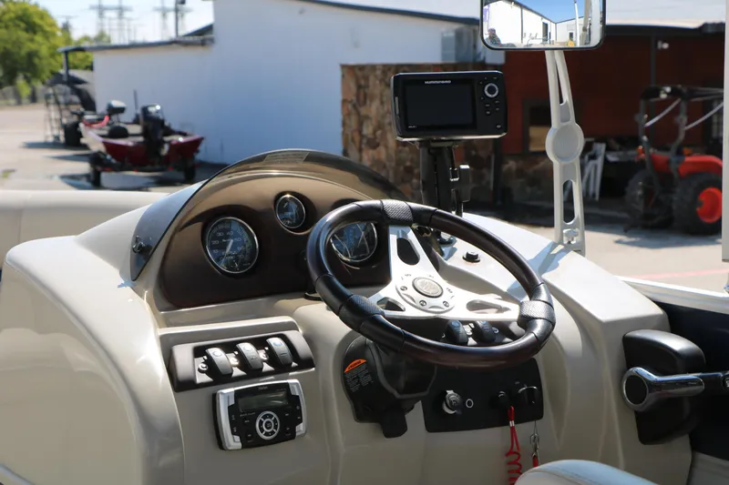 Slide: The Image of 2017 Berkshire 22 RFX Cts Tri-toon boat dashboard with steering wheel and controls. - 32