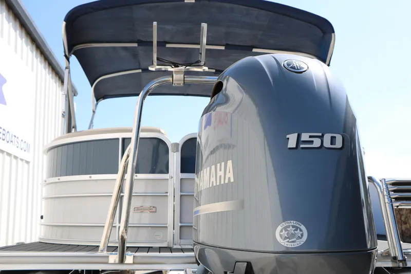 Slide: The Image of 2017 Berkshire 22 RFX Cts Tri-toon with Yamaha 150 engine, docked under canopy. - 9