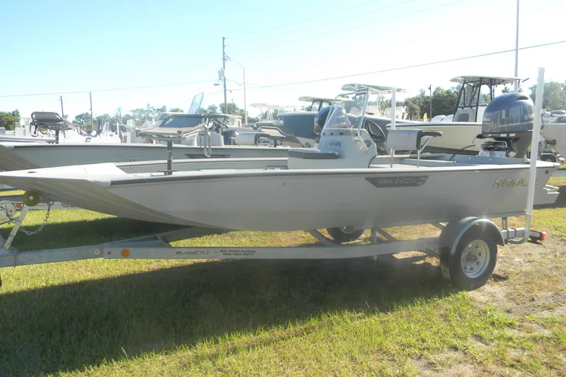 The Image of 2025 SeaArk Shadow 18 t boat on trailer, displayed outdoors in a dealership lot. - 1