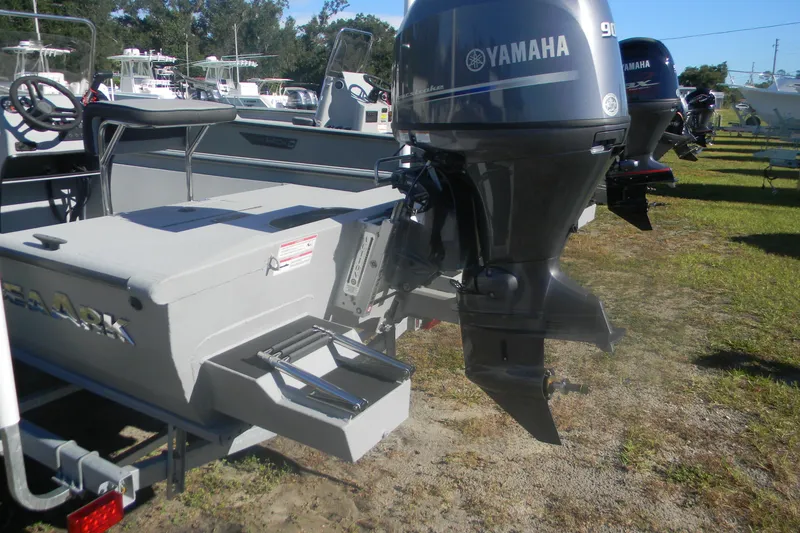 Slide: The Image of 2025 SeaArk Shadow 18 t boat with Yamaha outboard motor, parked on grass. - 2