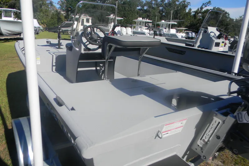 Slide: The Image of 2025 SeaArk Shadow 18 t boat with steering console, parked on grass. - 4