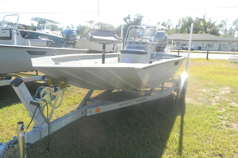 Slide: The Image of 2025 SeaArk Shadow 18 t boat on trailer, displayed outdoors in sunlight. - 7