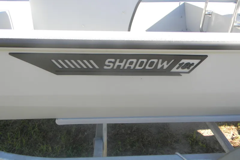 Slide: The Image of 2025 SeaArk Shadow 18 t boat side view with logo detail. - 8