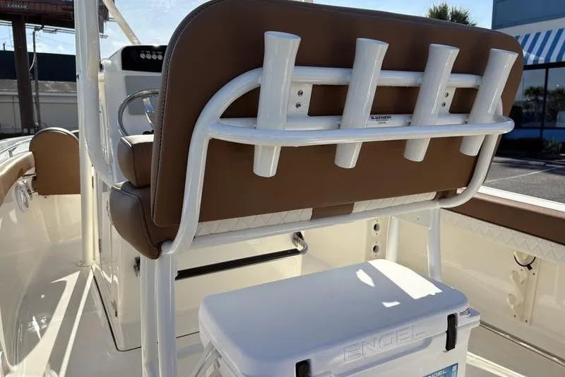 Slide: The Image of 2025 Pioneer 202 Islander boat interior with rod holders and cooler. - 10