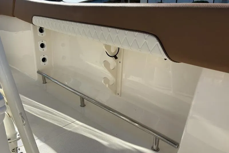 Slide: The Image of Interior view of 2025 Pioneer 202 Islander boat, featuring cushioned seating and rod holders. - 11