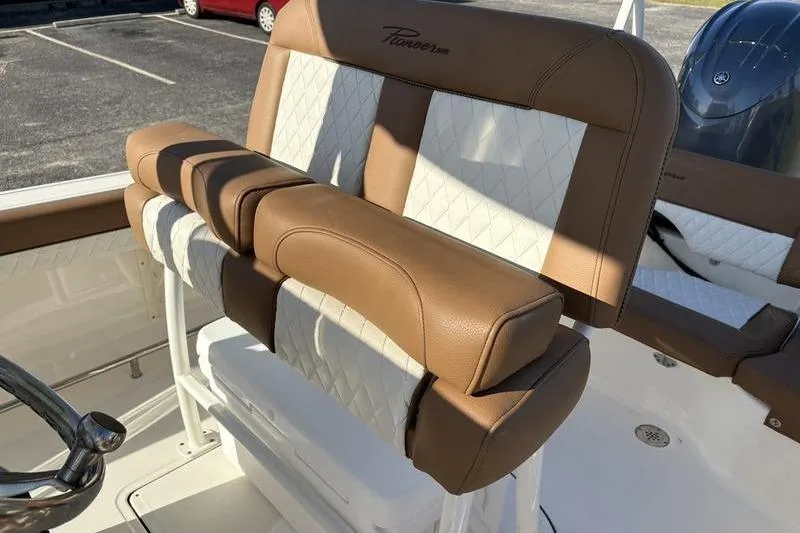 Slide: The Image of 2025 Pioneer 202 Islander boat seating with brown and white upholstery. - 13