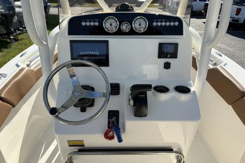Slide: The Image of 2025 Pioneer 202 Islander boat dashboard with Garmin navigation, steering wheel, and control panel. - 17