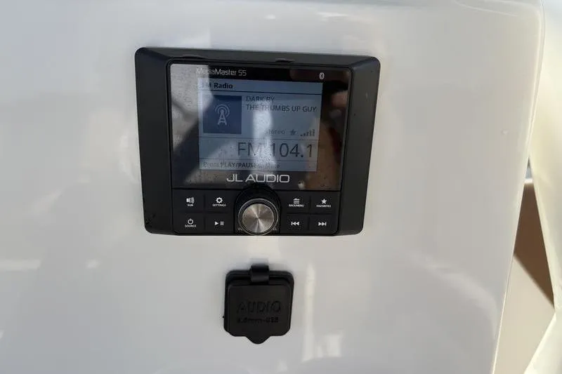 Slide: The Image of Audio system on 2025 Pioneer 202 Islander boat, displaying FM 104.1 on JL Audio unit. - 18