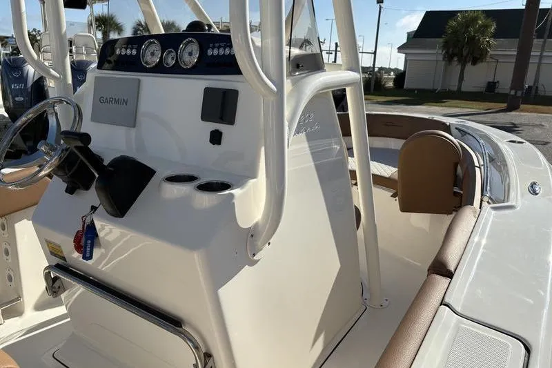 Slide: The Image of 2025 Pioneer 202 Islander boat console with Garmin navigation system and seating area. - 21