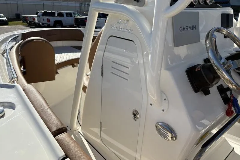 Slide: The Image of 2025 Pioneer 202 Islander boat interior with Garmin navigation system and seating area. - 22