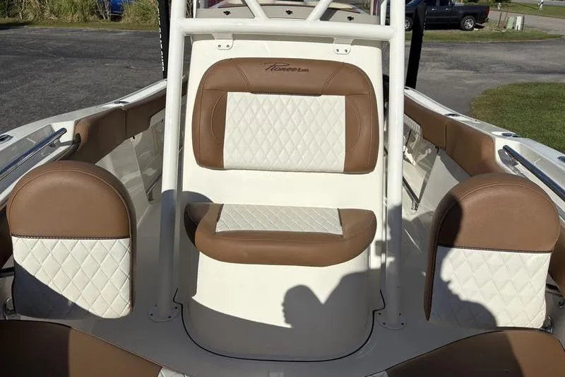 Slide: The Image of 2025 Pioneer 202 Islander boat interior with brown and white cushioned seating. - 24