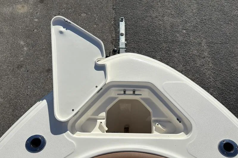 Slide: The Image of 2025 Pioneer 202 Islander boat bow storage compartment open on trailer. - 26