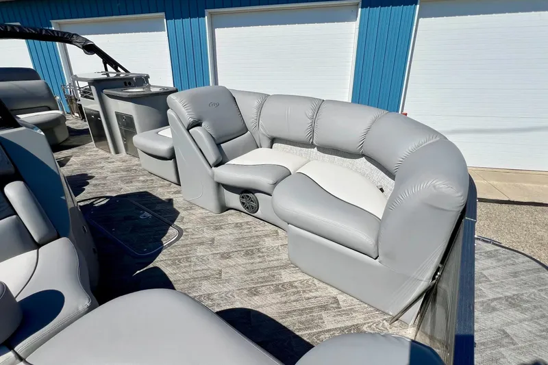 Slide: The Image of 2018 Manitou MD 25 TriToon boat with luxurious gray seating and modern interior design. - 18
