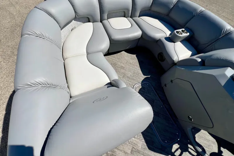 Slide: The Image of Luxurious seating on 2018 Manitou MD 25 TriToon boat, featuring plush gray upholstery. - 22