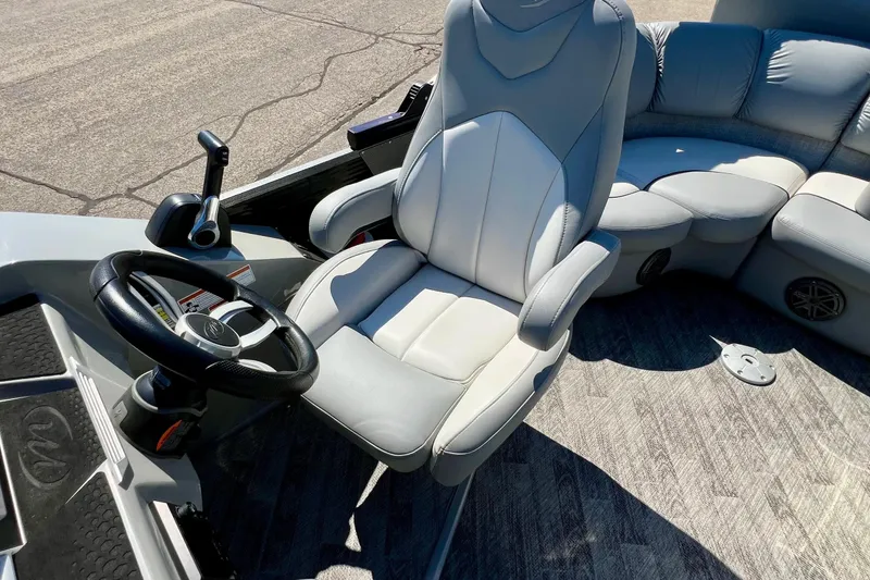 Slide: The Image of 2018 Manitou MD 25 TriToon boat interior with steering wheel and seating. - 26