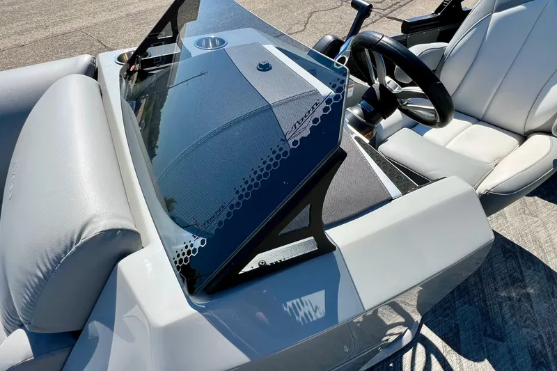 Slide: The Image of 2018 Manitou MD 25 TriToon boat interior with steering wheel and seating. - 28