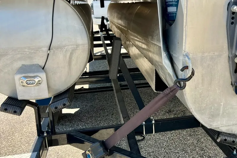Slide: The Image of 2018 Manitou MD 25 TriToon pontoons on trailer, secured with a strap. - 29
