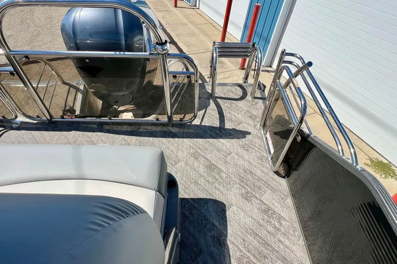 Slide: The Image of 2018 Manitou MD 25 TriToon boat interior with seating and railing details. - 4