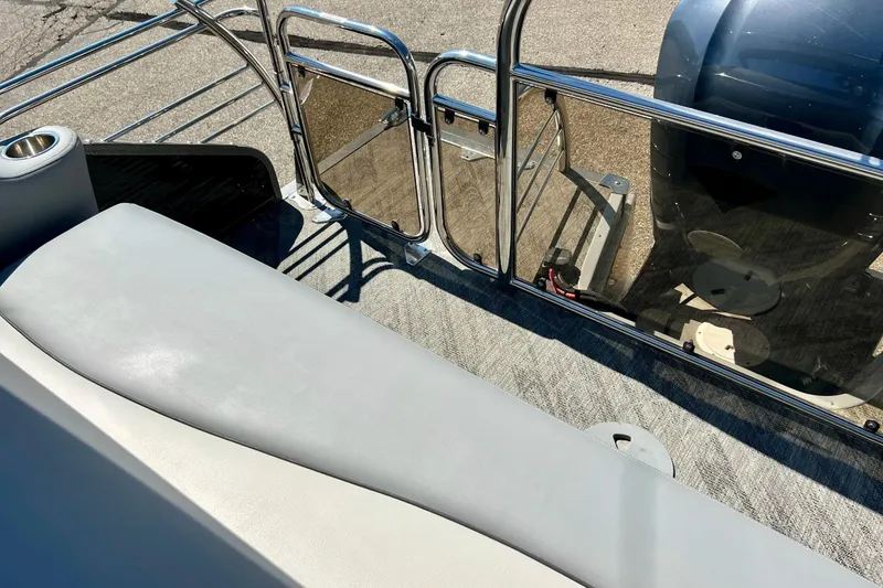 Slide: The Image of 2018 Manitou MD 25 TriToon boat interior with seating and railing details. - 5