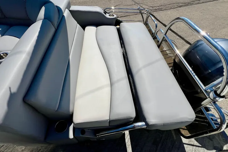 Slide: The Image of 2018 Manitou MD 25 TriToon boat with gray seating and stainless steel railings. - 9