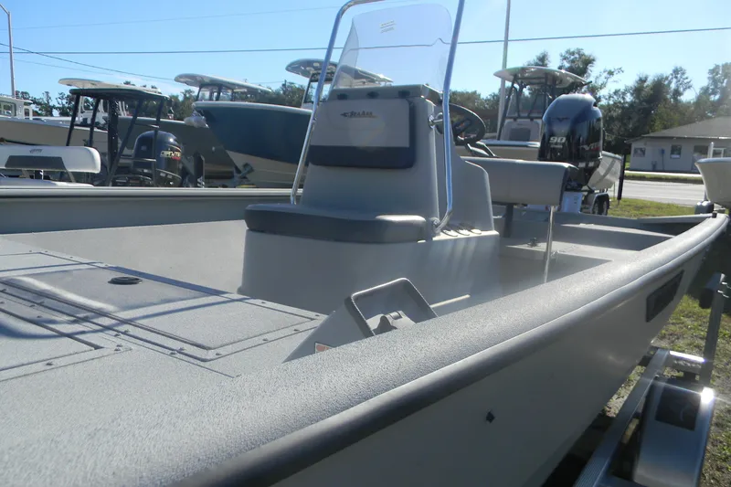 Slide: The Image of 2025 SeaArk Shadow 20 t boat with center console and seating, displayed outdoors. - 10