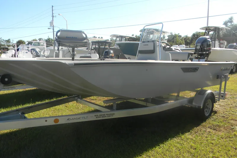 Slide: The Image of 2025 SeaArk Shadow 20 t boat on trailer, displayed outdoors in a marine dealership. - 11