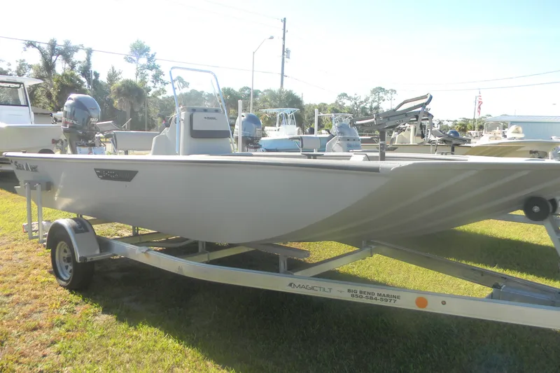 Slide: The Image of 2025 SeaArk Shadow 20 t boat on trailer, displayed outdoors in a marine setting. - 13
