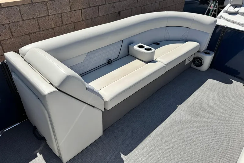 Slide: The Image of 2022 Crest Classic DLX 240 SLRC boat interior with plush seating and cup holders. - 10