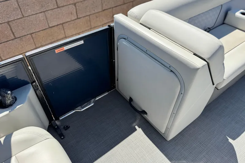 Slide: The Image of 2022 Crest Classic DLX 240 SLRC boat interior with white seating and storage compartment. - 12