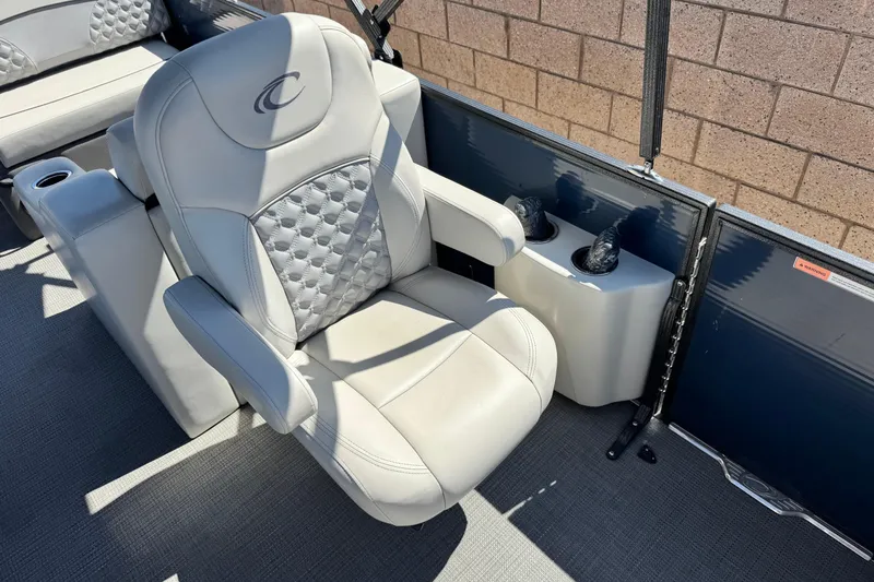 Slide: The Image of Captain's chair on 2022 Crest Classic DLX 240 SLRC pontoon boat, featuring plush upholstery. - 13