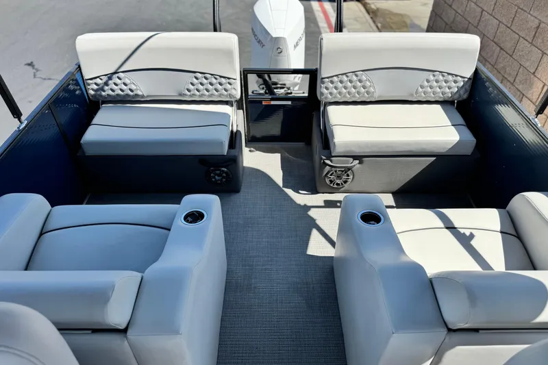 Slide: The Image of 2022 Crest Classic DLX 240 SLRC boat interior with plush seating and cup holders. - 15